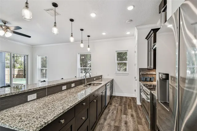 a kitchen with granite countertop a stove sink and cabinets