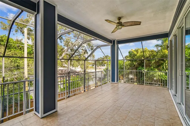 an empty room with ceiling fan and window