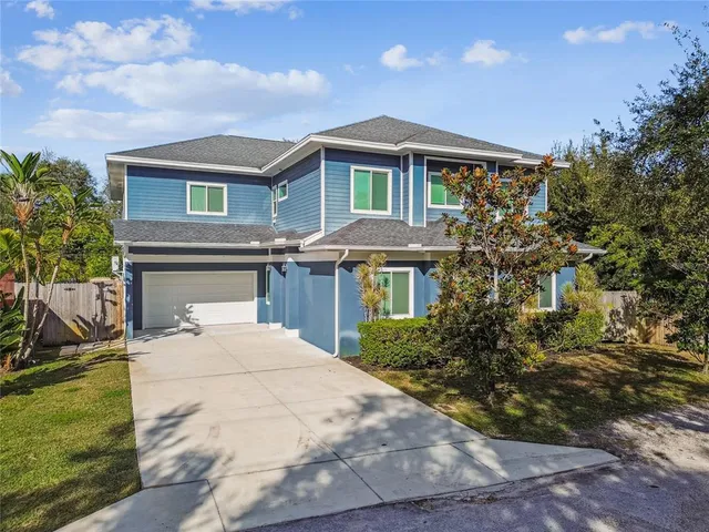 a view of a hallway with wooden floor and a kitchen