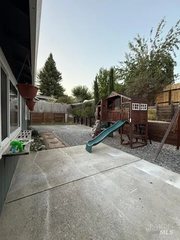 a view of a backyard with sitting area