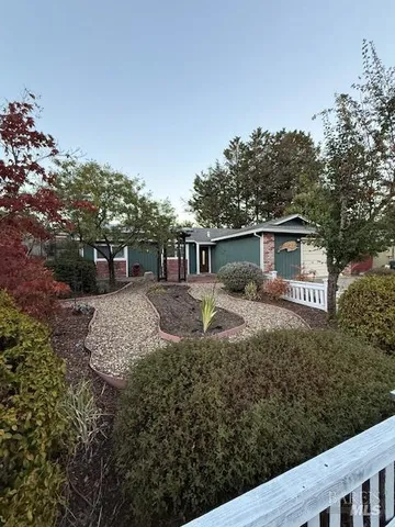 a view of a chair and table in the backyard