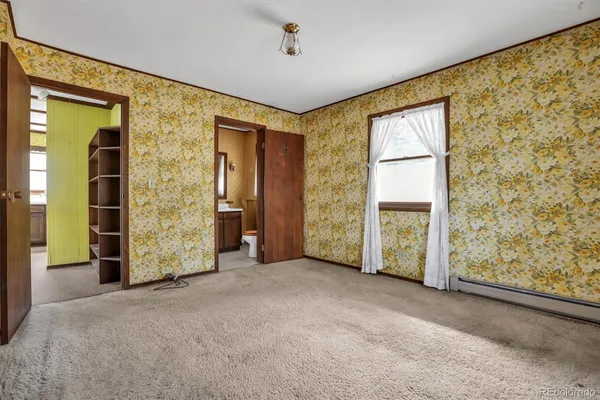 an empty room with windows and closet