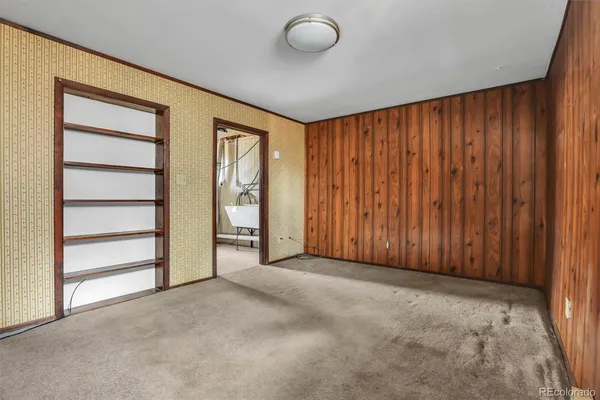 an empty room with a wooden door