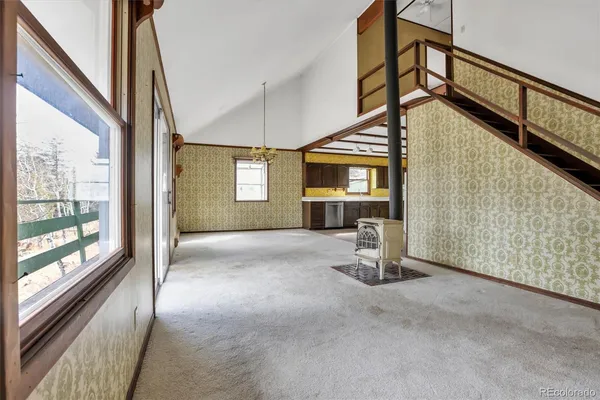 a view of empty room with wooden floor and windows