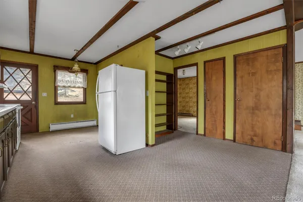 a view of empty room with furniture and a window