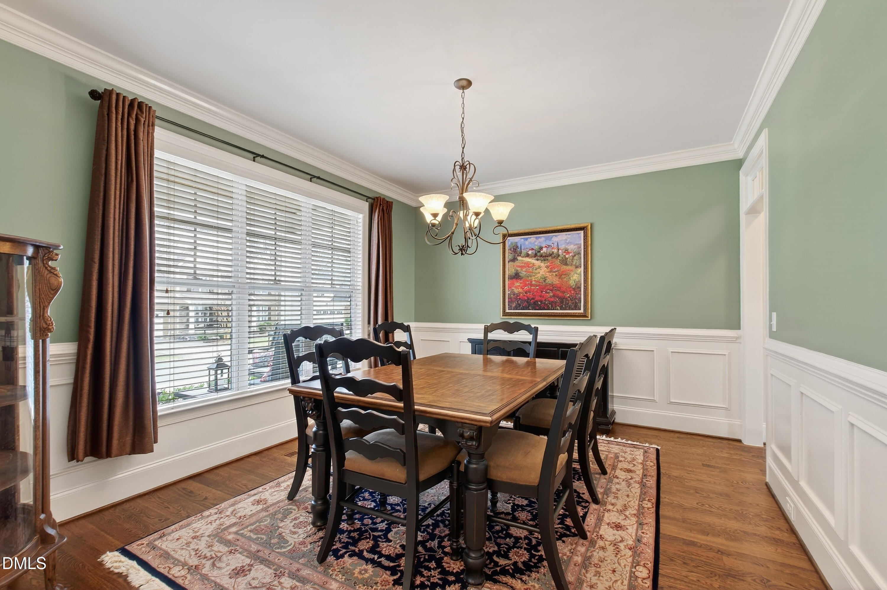 417 Wanderview Lane Holly Springs, NC 27540 - Photo 11 of 86 a view of a dining room with furniture window and wooden floor