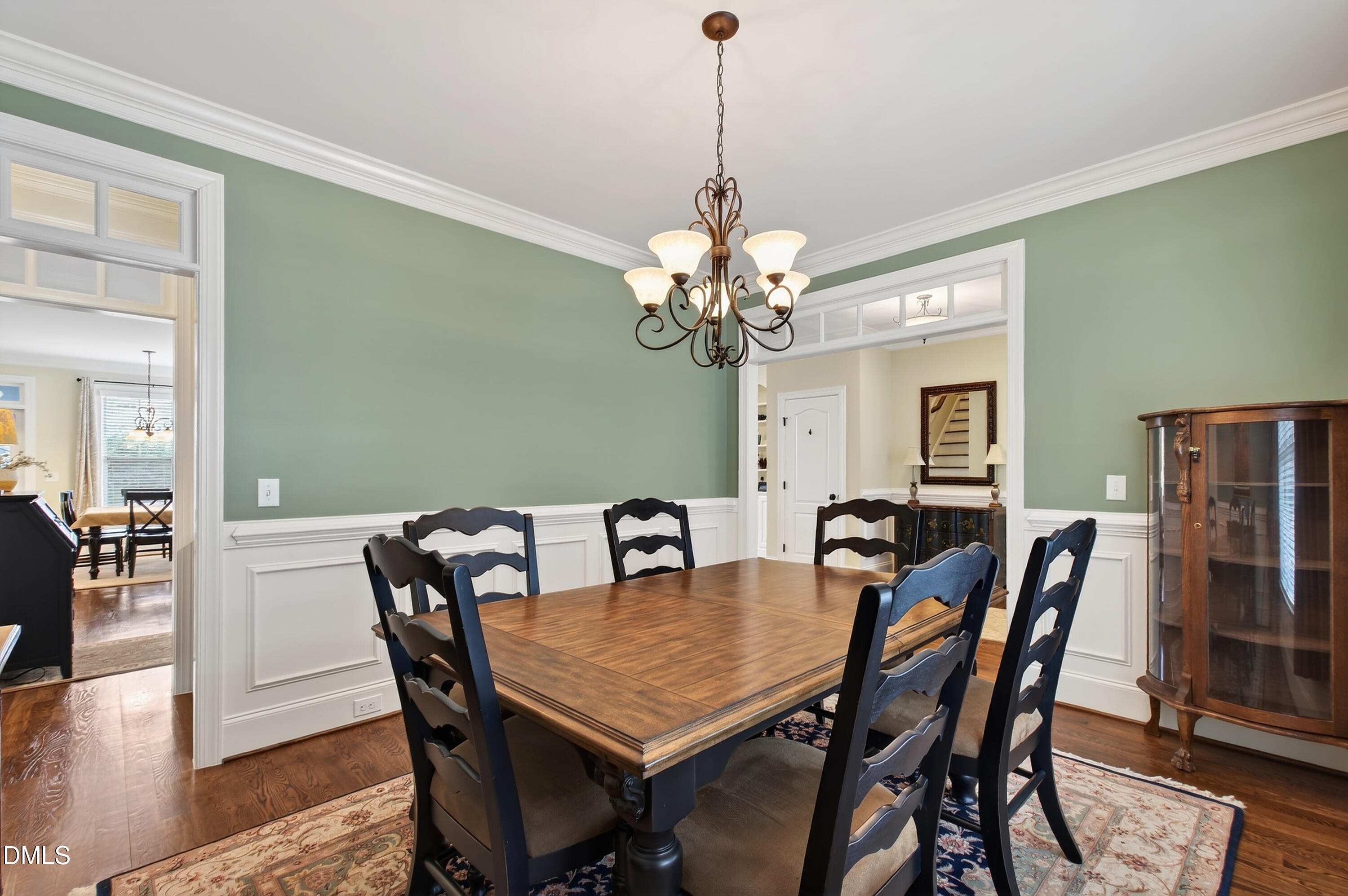 417 Wanderview Lane Holly Springs, NC 27540 - Photo 12 of 86 a view of a dining room with furniture wooden floor and chandelier