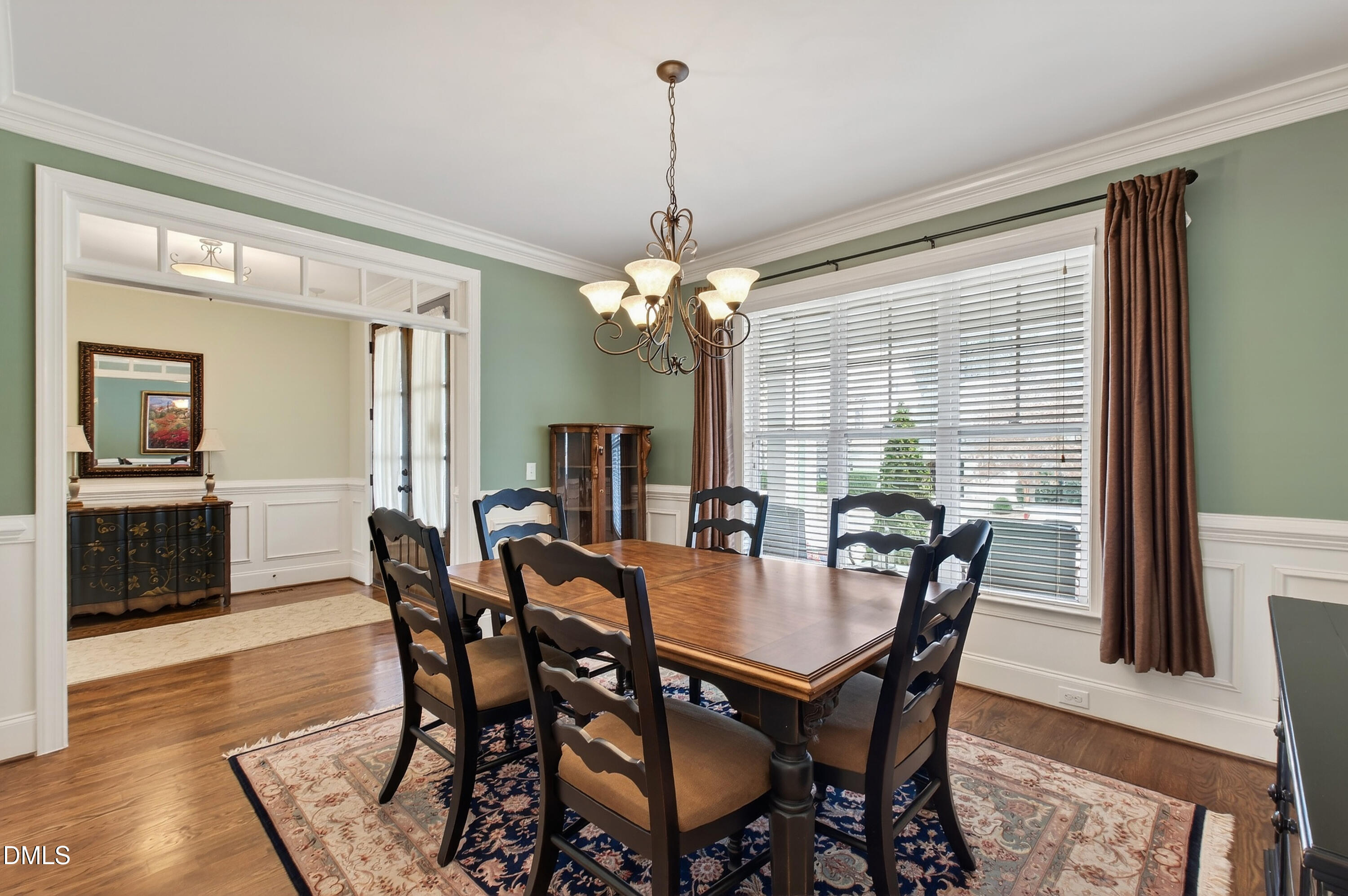 417 Wanderview Lane Holly Springs, NC 27540 - Photo 13 of 86 a view of a dining room with furniture window and wooden floor