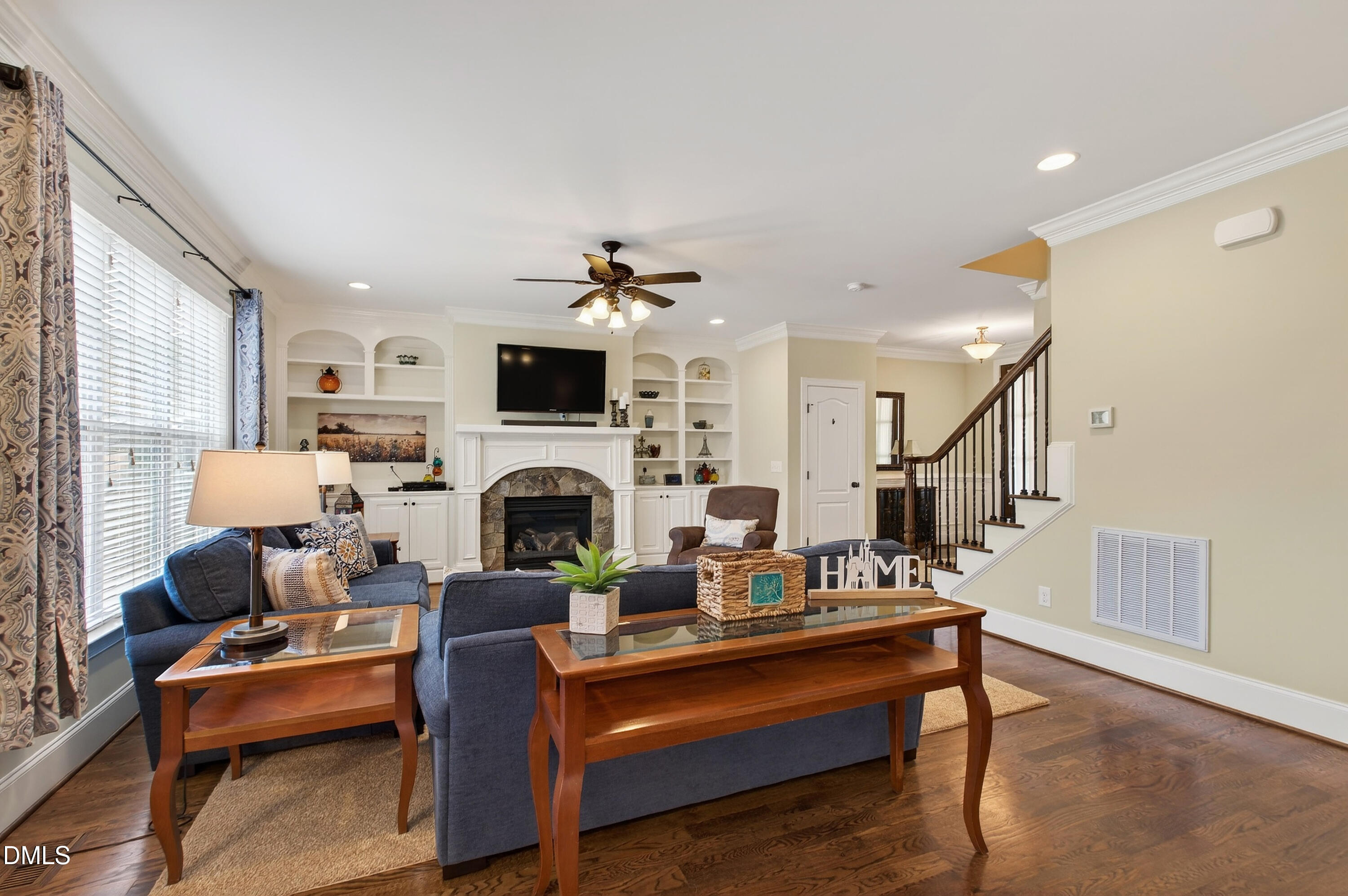 417 Wanderview Lane Holly Springs, NC 27540 - Photo 15 of 86 a living room with furniture a fireplace and a flat screen tv