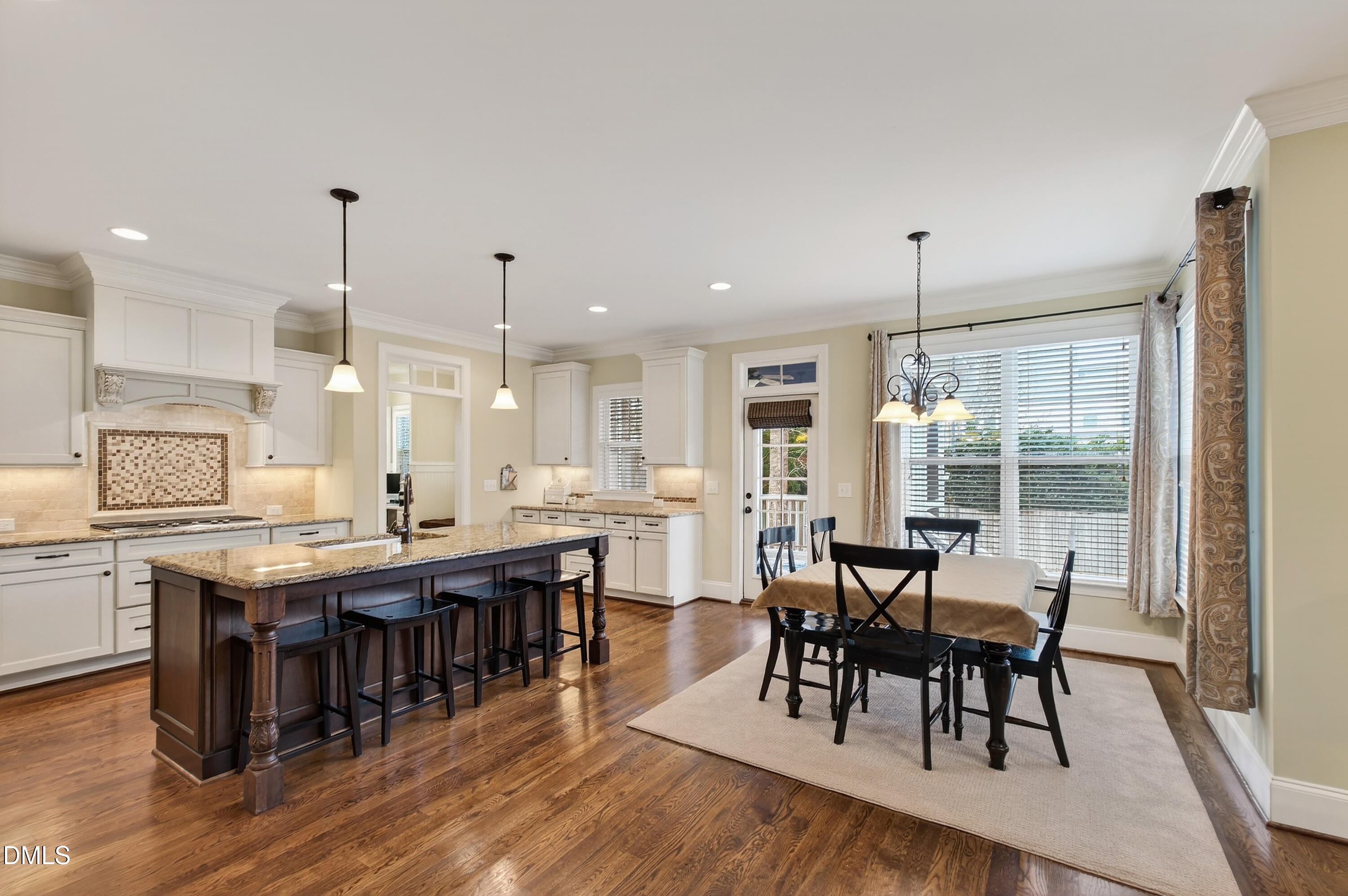 417 Wanderview Lane Holly Springs, NC 27540 - Photo 20 of 86 a large kitchen with lots of counter space and dining table