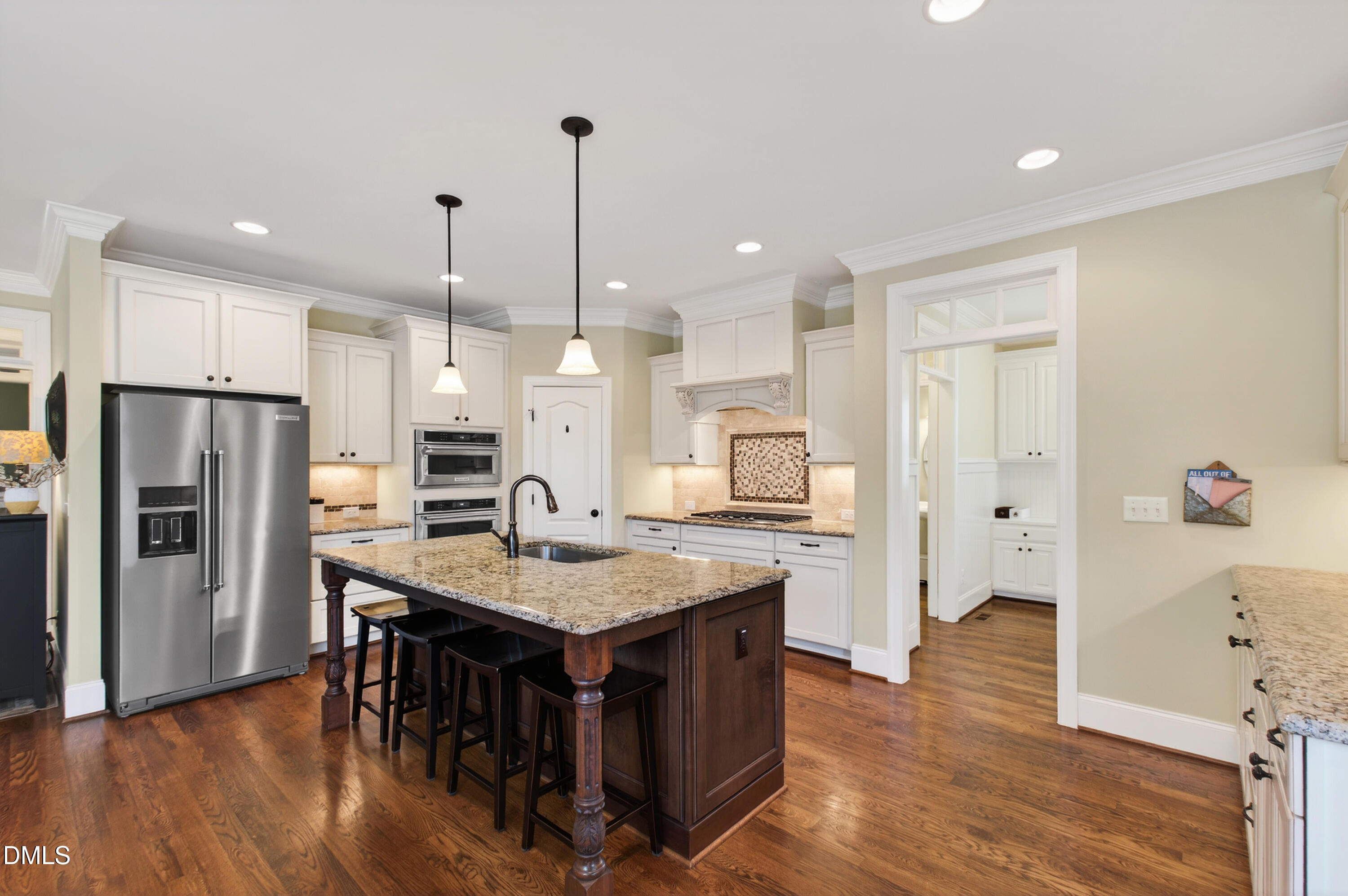 417 Wanderview Lane Holly Springs, NC 27540 - Photo 23 of 86 a kitchen with stainless steel appliances granite countertop a refrigerator a stove and a wooden floors