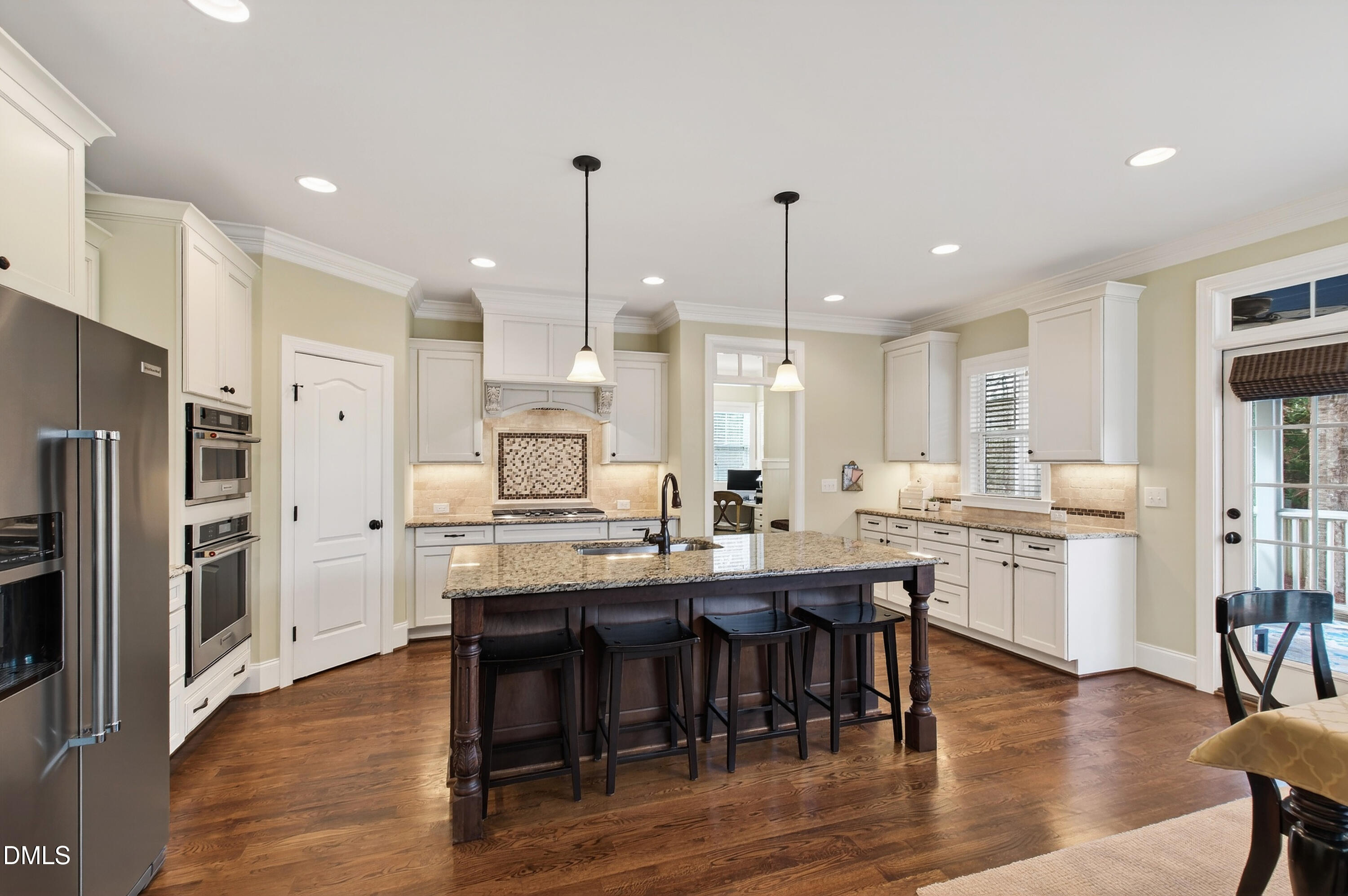 417 Wanderview Lane Holly Springs, NC 27540 - Photo 24 of 86 a large kitchen with a table and chairs
