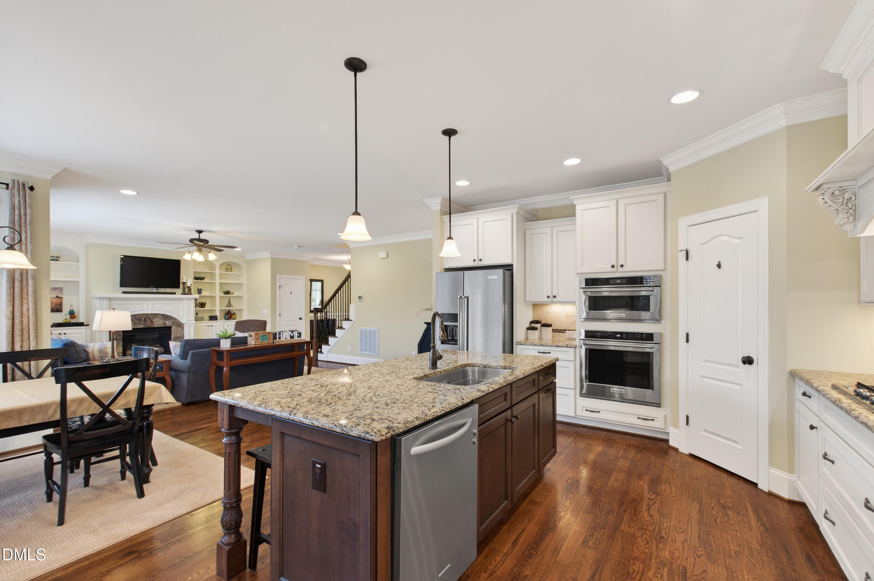 417 Wanderview Lane Holly Springs, NC 27540 - Photo 26 of 86 a kitchen with stainless steel appliances kitchen island granite countertop a stove refrigerator and chairs