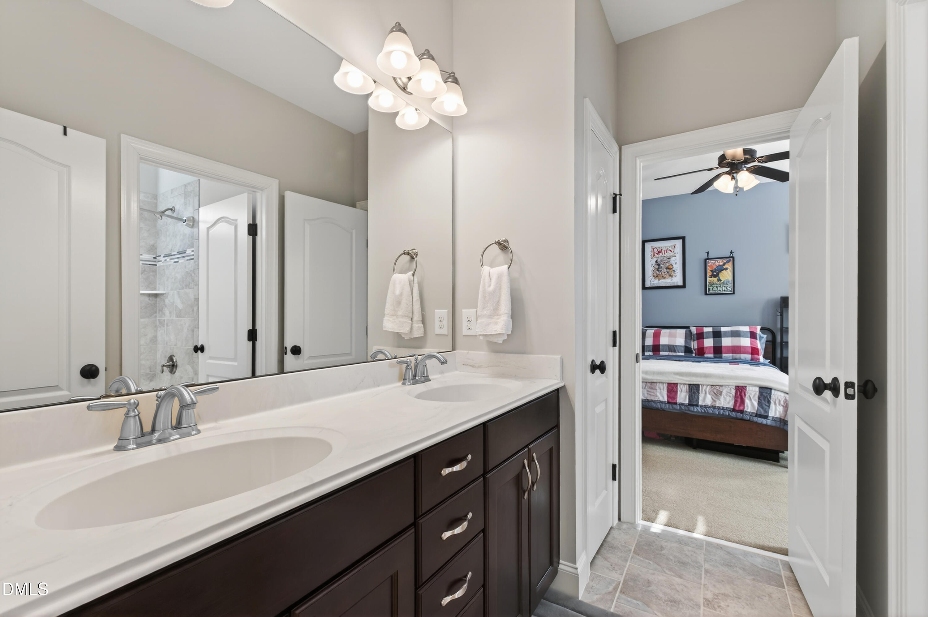 417 Wanderview Lane Holly Springs, NC 27540 - Photo 48 of 86 a en suite bathroom with a double vanity sink and a mirror