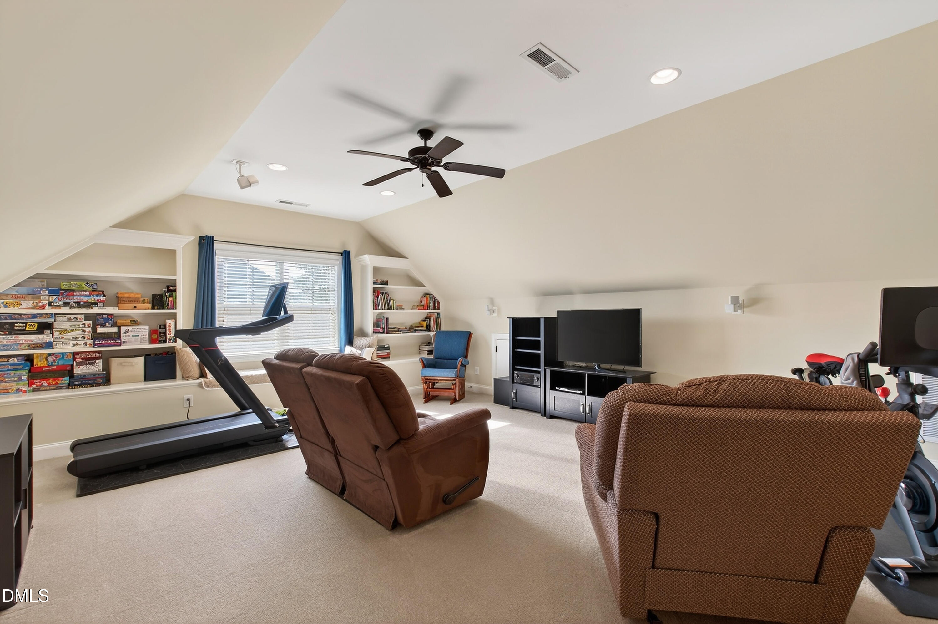 417 Wanderview Lane Holly Springs, NC 27540 - Photo 52 of 86 a living room with furniture and a flat screen tv