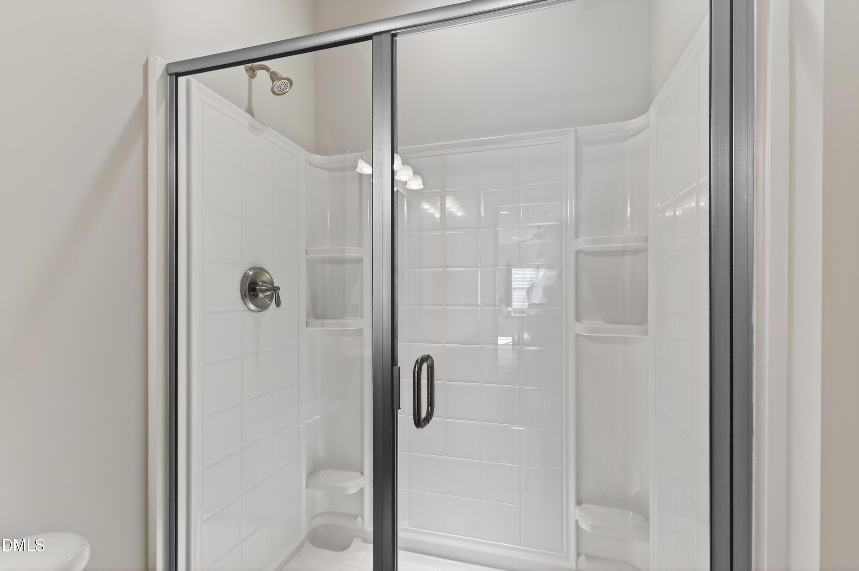 417 Wanderview Lane Holly Springs, NC 27540 - Photo 56 of 86 a bathroom with a glass shower door