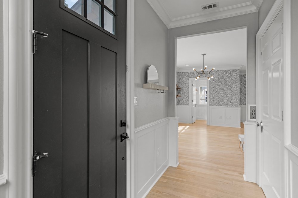 1609 Hartford Road, Unit A Austin, TX 78703 - Photo 11 of 39 Natural light illuminates blonde hardwood flooring and wainscoting in this elegant entry hall.