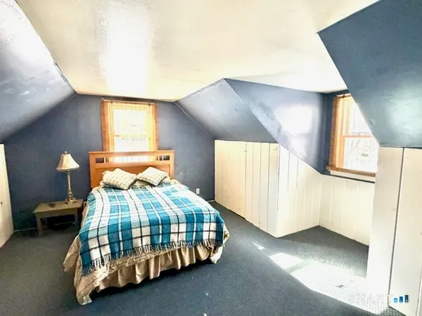 a bedroom with a bed and window