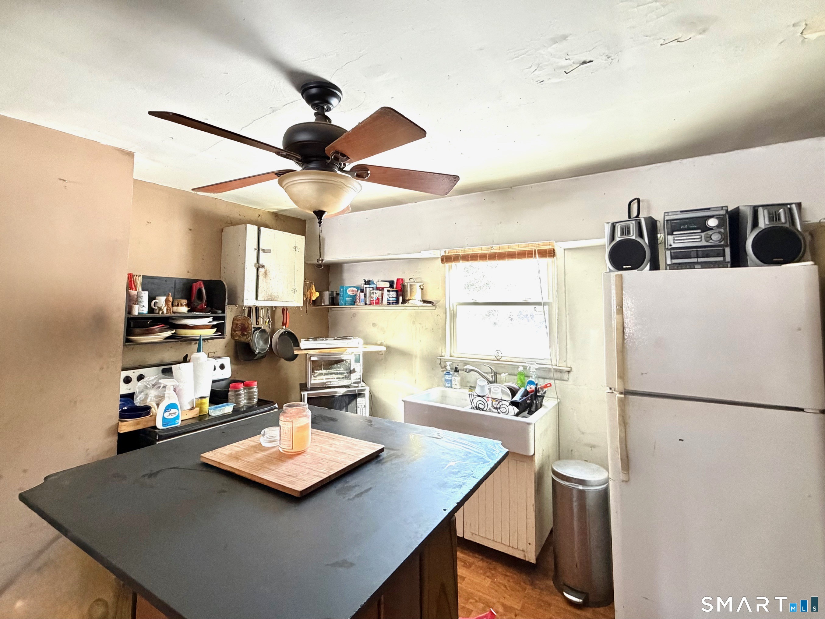 360 Garder Road Monroe, CT 06468 - Photo 7 of 15 a living room with kitchen island furniture a chandelier and a table