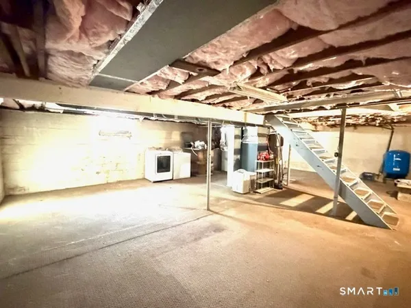 a view of a room with wooden stairs