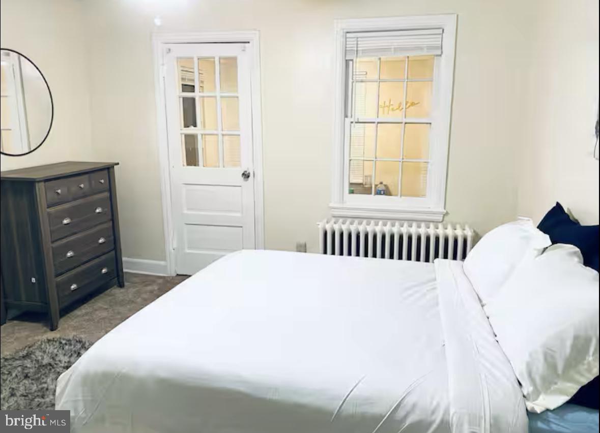 1268 Raum Street Northeast Washington, DC 20002 - Photo 13 of 46 a bedroom with a bed a window and closet