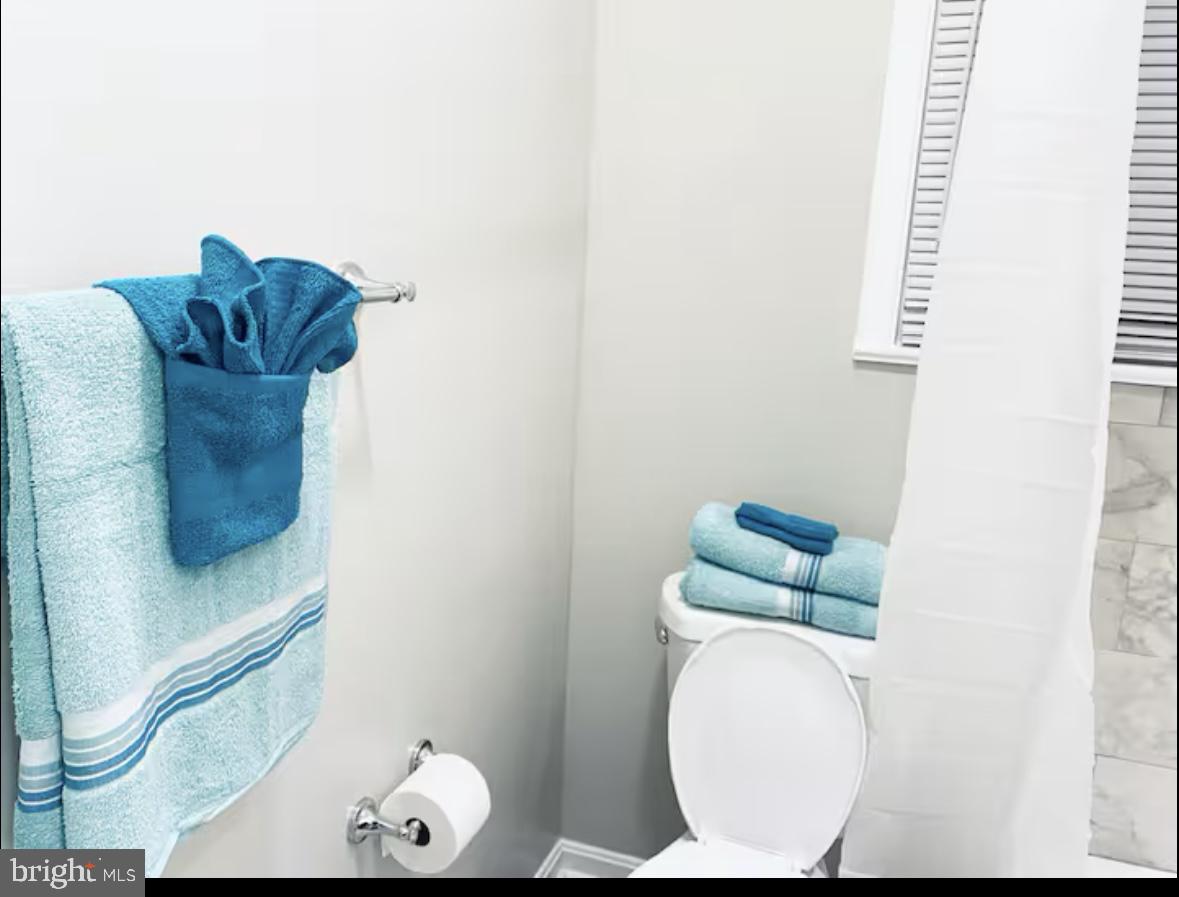 1268 Raum Street Northeast Washington, DC 20002 - Photo 16 of 46 a bathroom with a toilet and a mirror