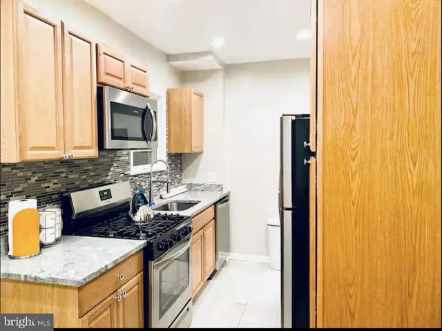 a bathroom with a sink a mirror and a shower