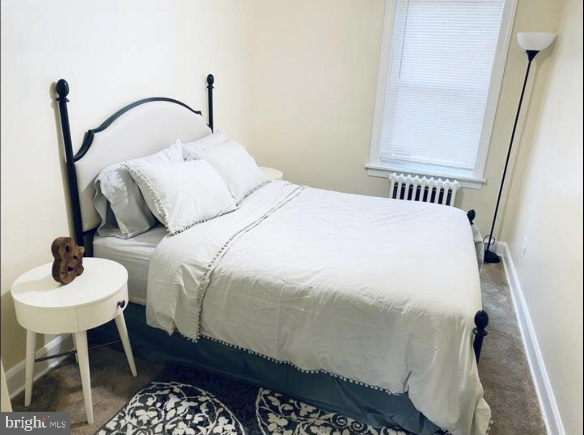 1268 Raum Street Northeast Washington, DC 20002 - Photo 34 of 46 a bedroom with a bed and a table