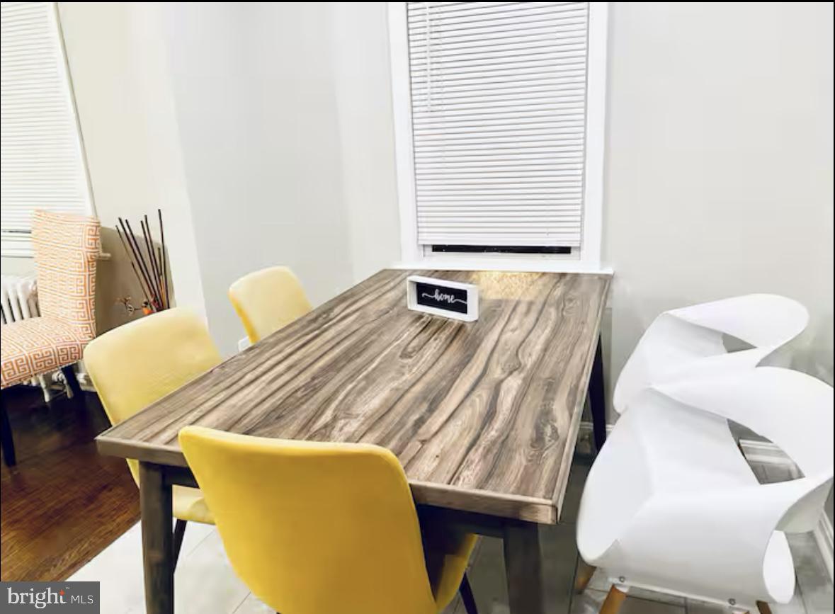 1268 Raum Street Northeast Washington, DC 20002 - Photo 36 of 46 a bedroom with a bed and wooden floor