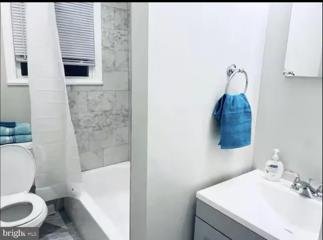 a kitchen with a refrigerator and a stove top oven
