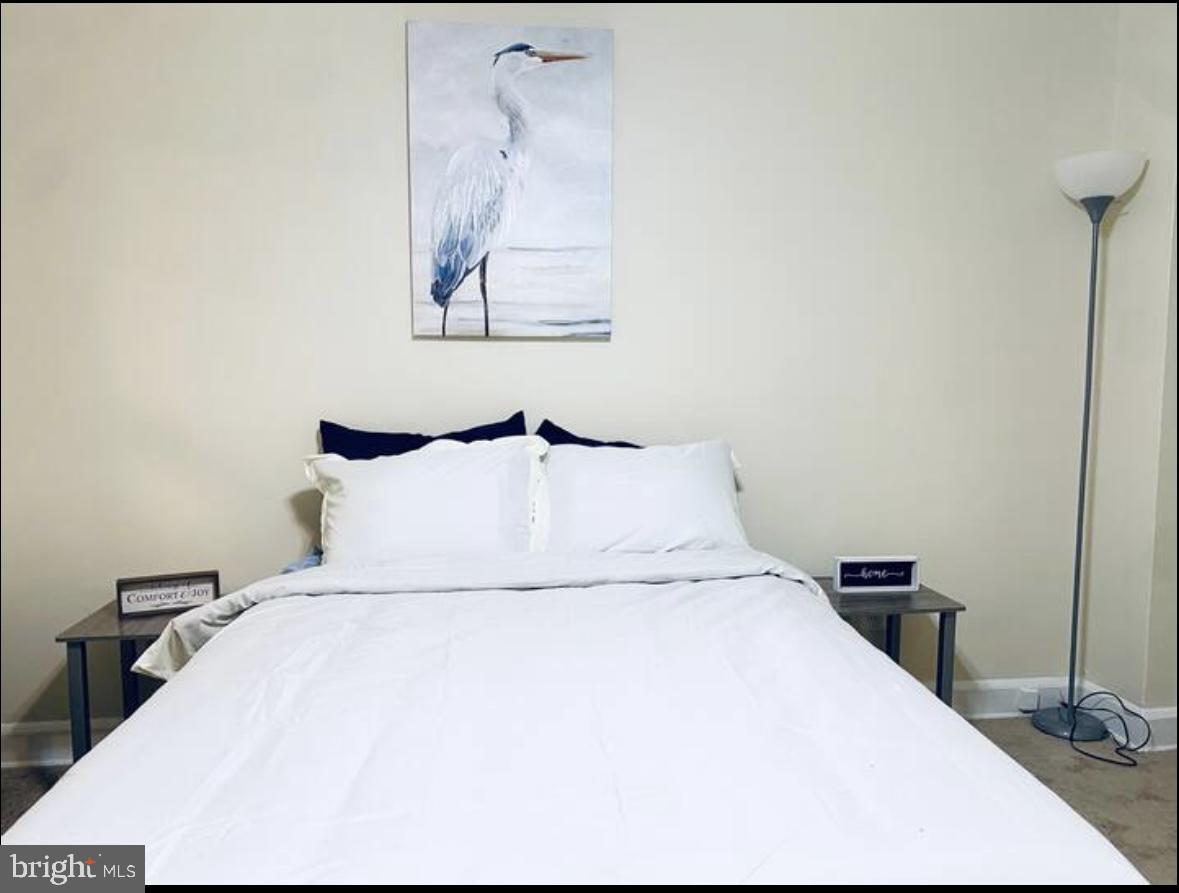1268 Raum Street Northeast Washington, DC 20002 - Photo 44 of 46 a large bed sitting in a bedroom and lamp