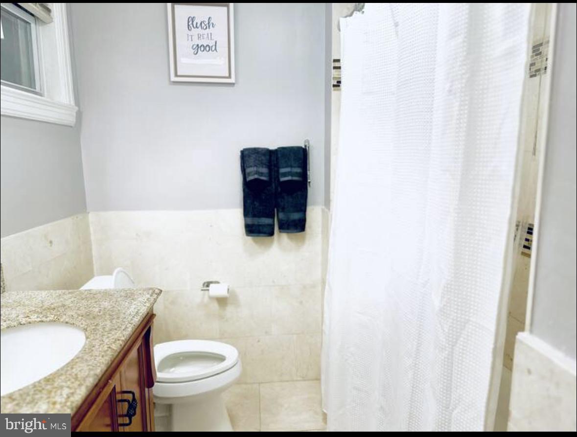 1268 Raum Street Northeast Washington, DC 20002 - Photo 45 of 46 a bathroom with a granite countertop sink and a mirror