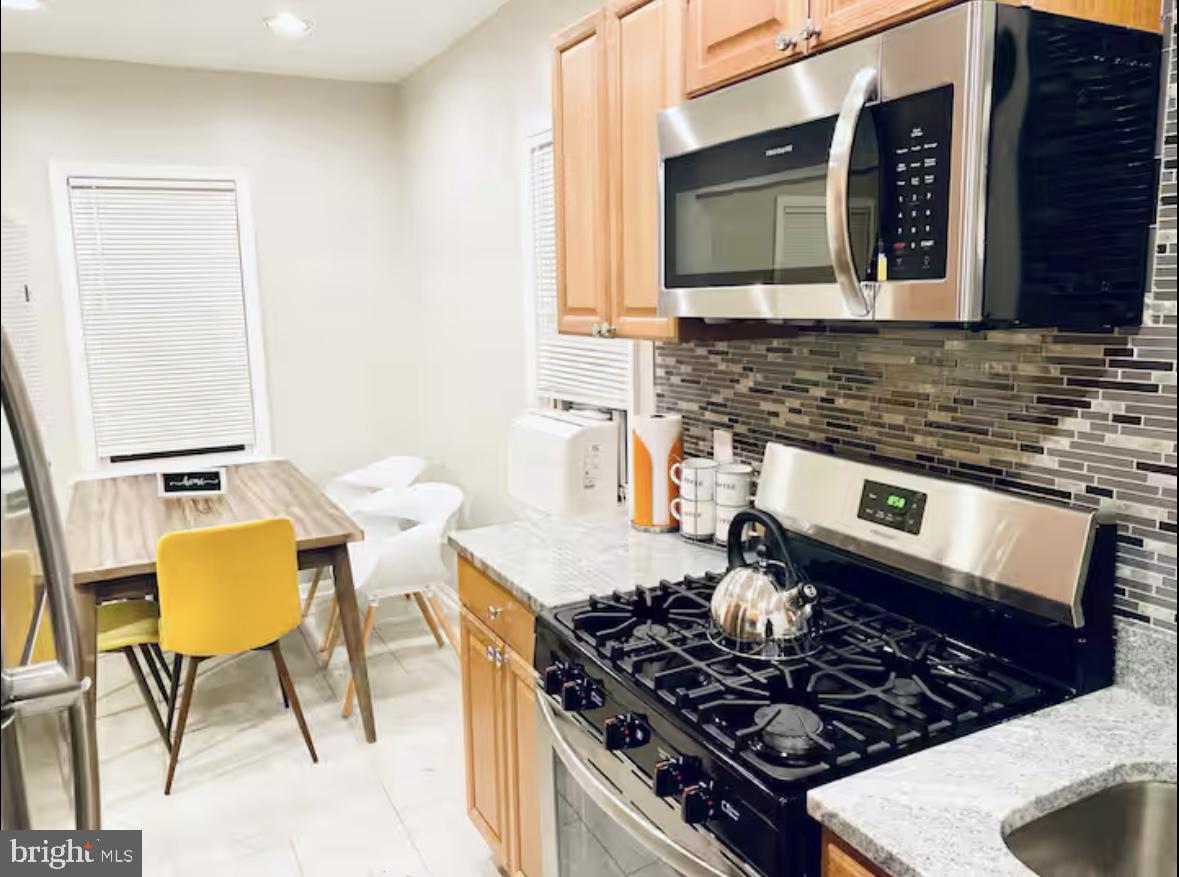 1268 Raum Street Northeast Washington, DC 20002 - Photo 46 of 46 a kitchen with a stove and a microwave