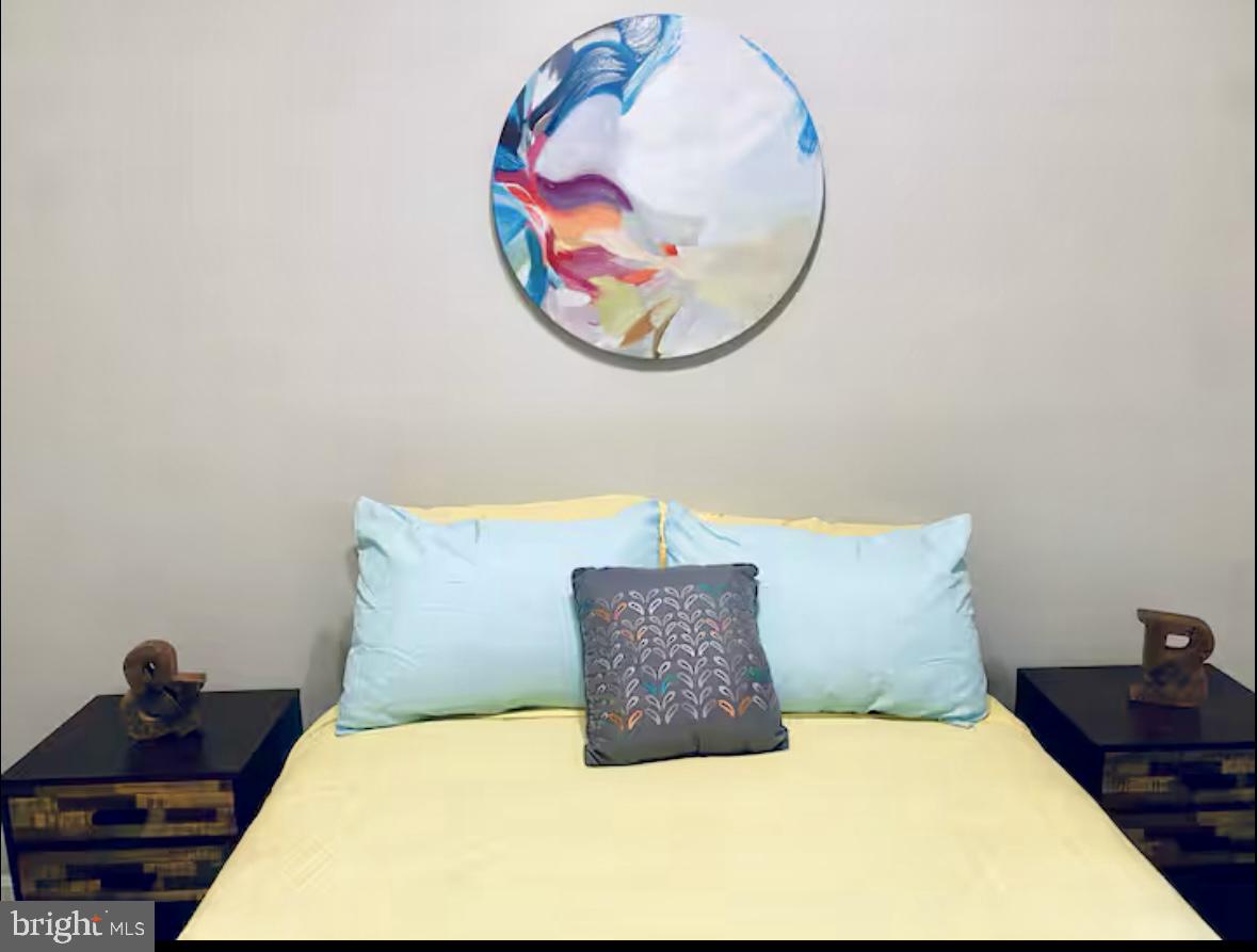 1268 Raum Street Northeast Washington, DC 20002 - Photo 7 of 46 a bedroom with a bed and a painting on the wall