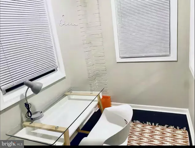 a view of a room with furniture and a chair