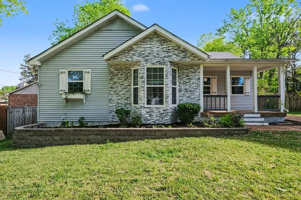 a view of a house with a yard and plants