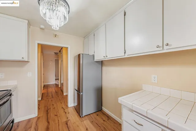 a view of kitchen cabinets and wooden floor