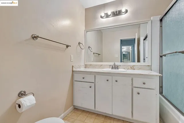 a bathroom with a granite countertop sink mirror and vanity