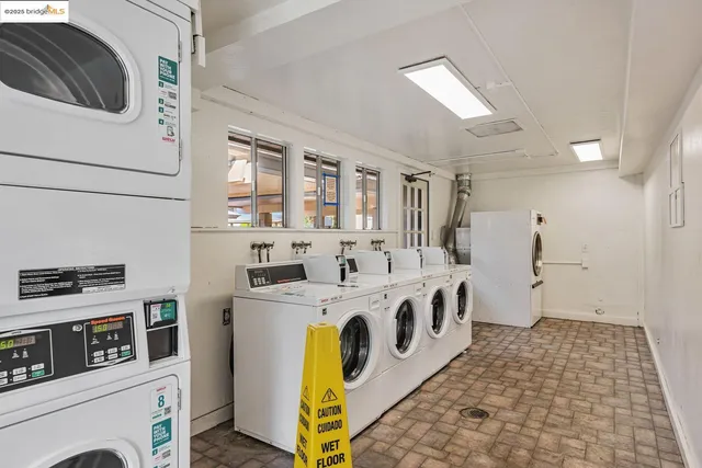 a utility room with stainless steel appliances granite countertop a stove and a microwave
