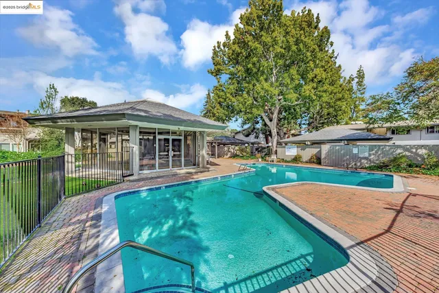 a view of a house with a yard patio and fire pit