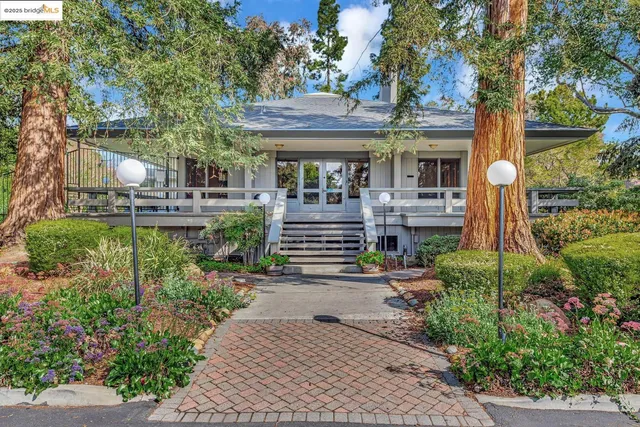 a front view of a house with a garden