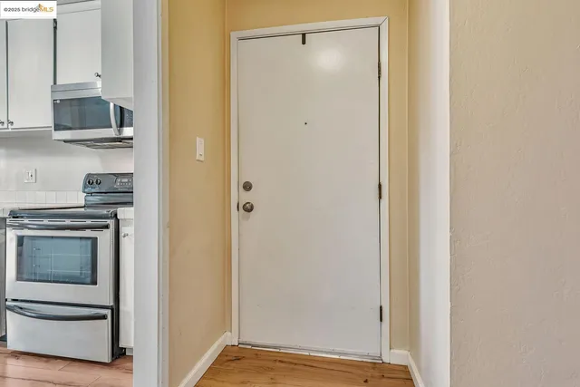 a view of kitchen with stainless steel appliances granite countertop cabinets and sink