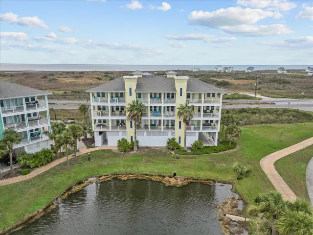 a view of a big building with a big yard and large trees