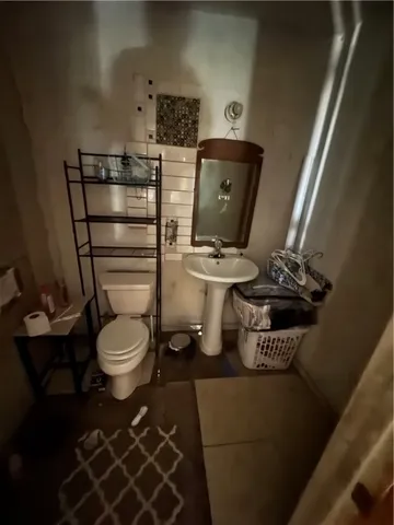 a bathroom with a toilet and a mirror