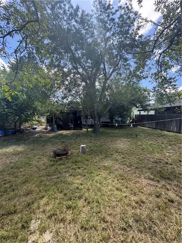 a view of a yard with a tree