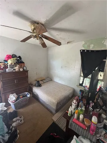 a bedroom with bed and window