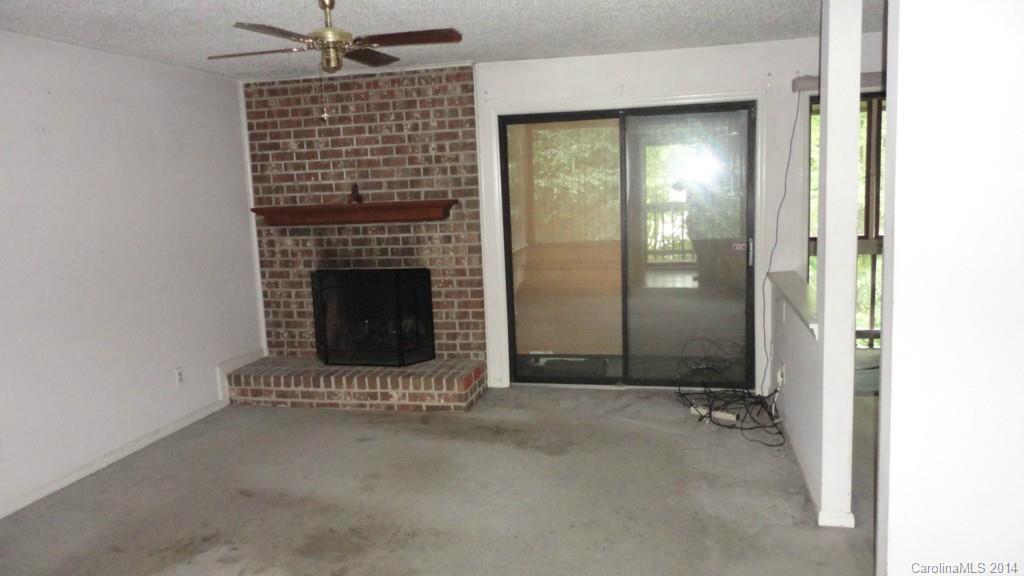 11014 Running Ridge Road, Unit 11014 Charlotte, NC 28226 - Photo 2 of 6 a view of an empty room with a fireplace