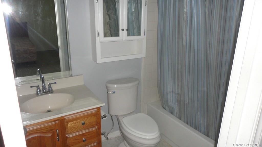 11014 Running Ridge Road, Unit 11014 Charlotte, NC 28226 - Photo 4 of 6 a bathroom with a granite countertop sink toilet and shower