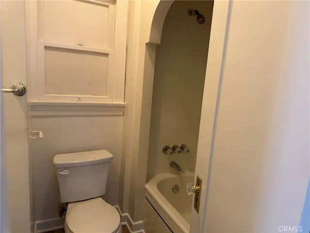 a white toilet sitting next to a bathroom sink