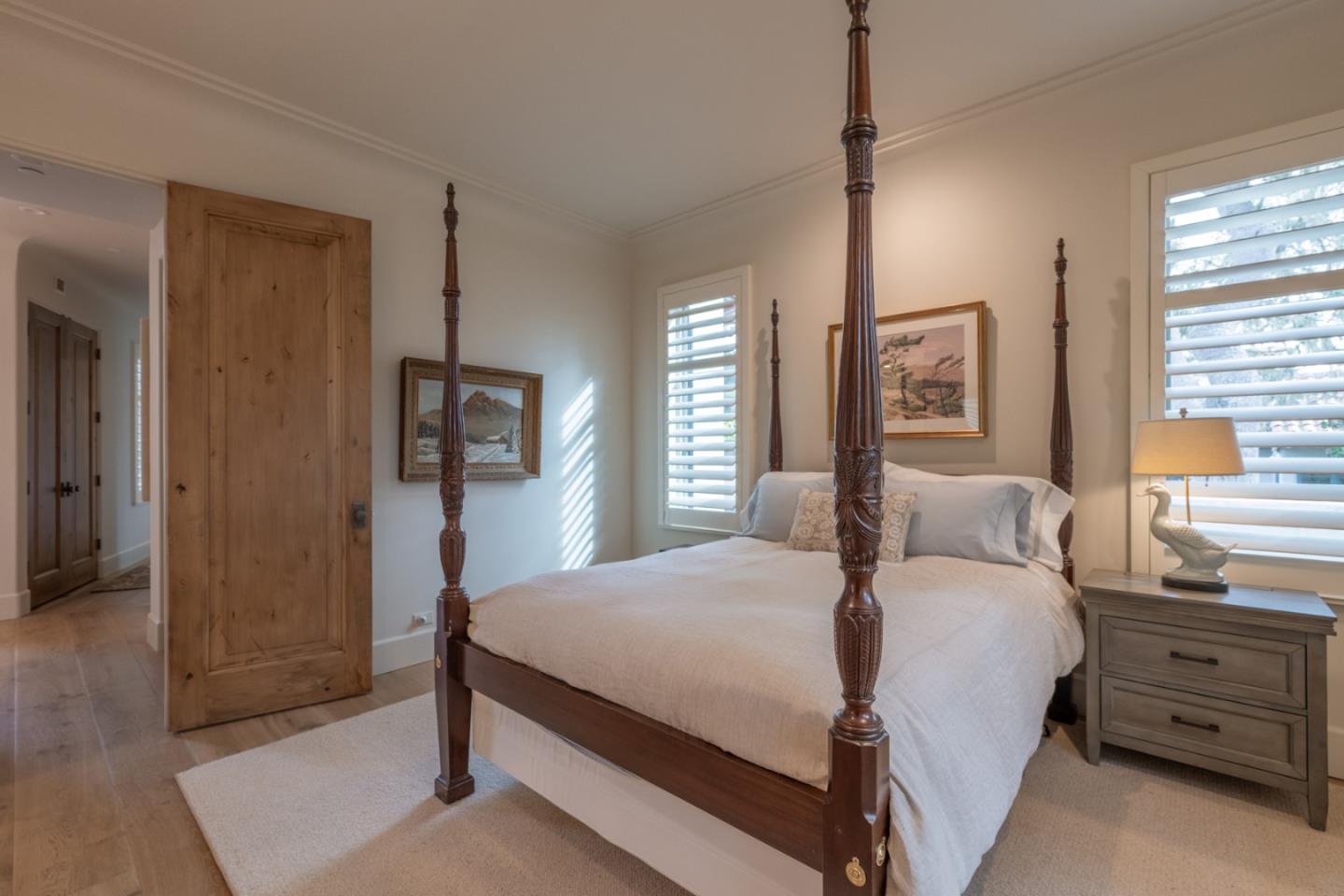 1041 Rodeo Road Pebble Beach, CA 93953 - Photo 11 of 18 a bedroom with a bed a dresser and a window
